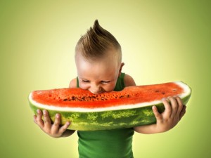 punk boy eating a big slice of watermelon